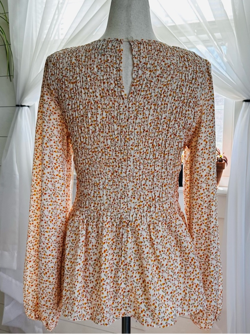 Lumiere long sleeve feminine Floral Print Smocked Peplum Top. 
Size: Small - Picture 5 of 11